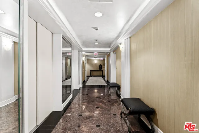 a hallway view with wooden floor and furniture