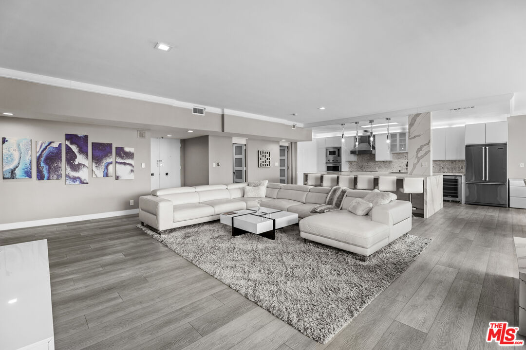 1333 South Beverly Glen Boulevard, Unit 605 Los Angeles, CA 90024 - Photo 4 of 27 a living room with furniture and wooden floor