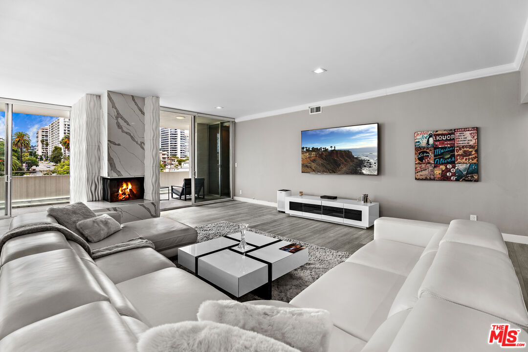 1333 South Beverly Glen Boulevard, Unit 605 Los Angeles, CA 90024 - Photo 6 of 27 a living room with furniture and a fireplace