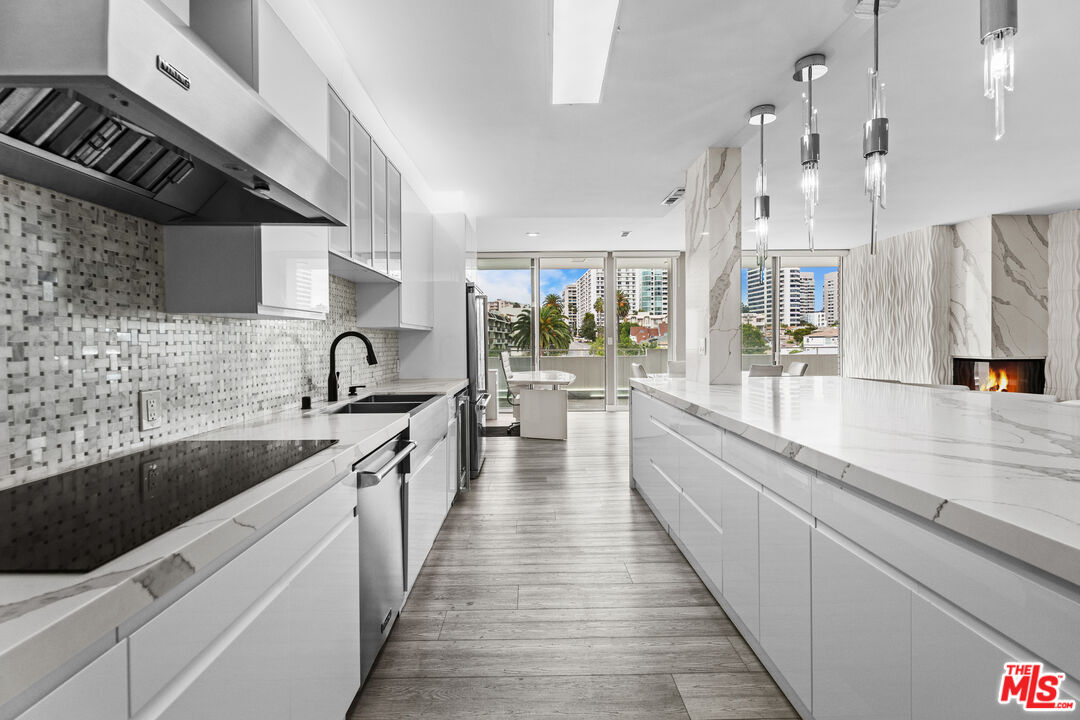 1333 South Beverly Glen Boulevard, Unit 605 Los Angeles, CA 90024 - Photo 9 of 27 a large kitchen with stainless steel appliances lots of counter space and a sink
