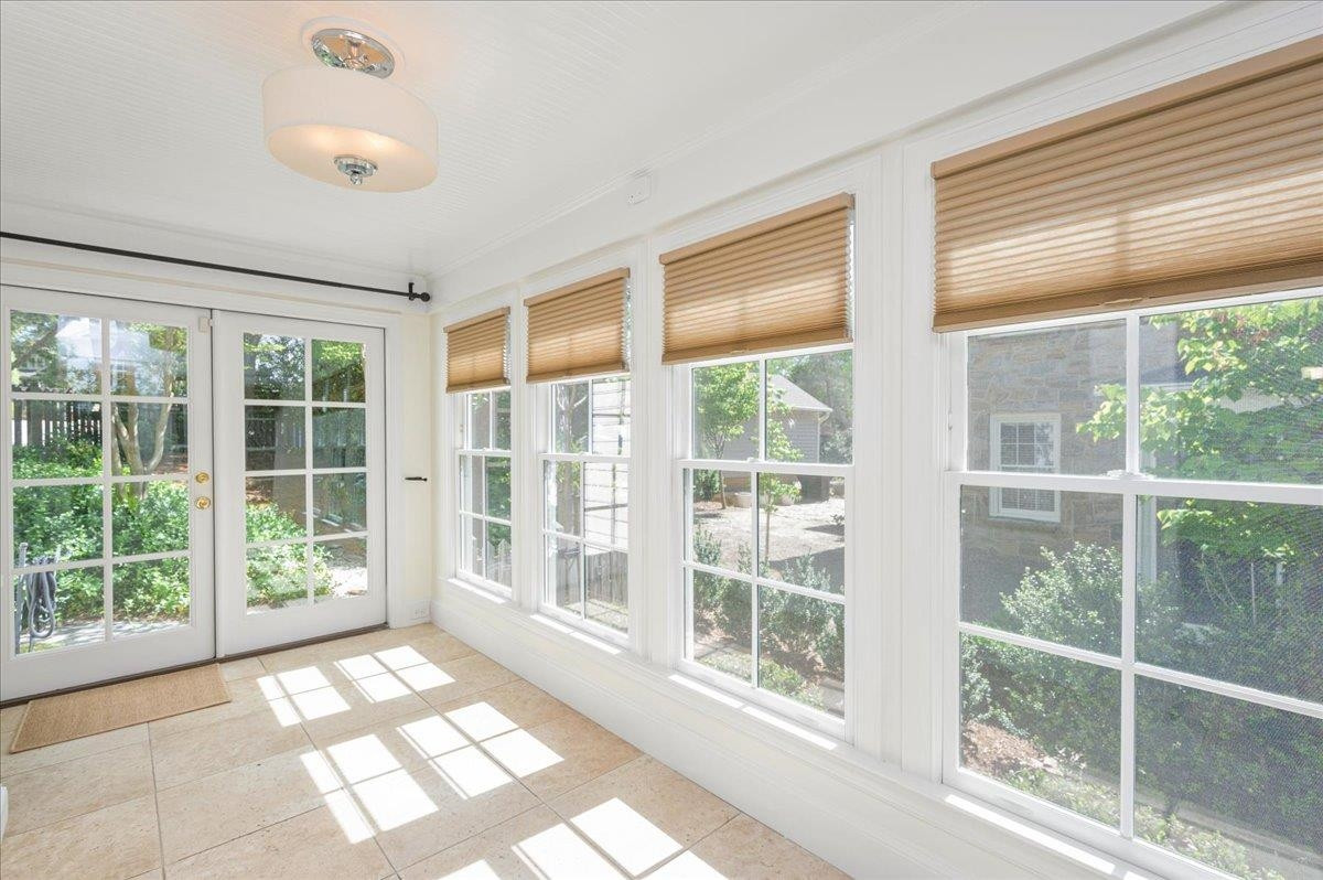 2511 Kenmore Drive Raleigh, NC 27608 - Photo 18 of 34 tiled with bookshelves - Perfect for lounging with morning coffee or evening spirits or use as your own personal home office space - access also to main floor bedroom Office/Sunroom