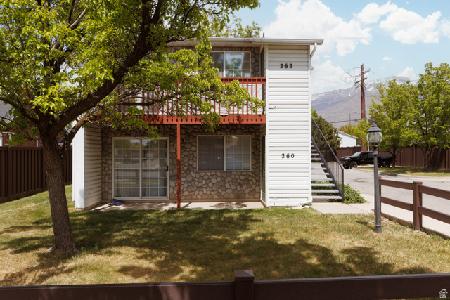 260 400 North, Unit 1 Orem, UT 84057 - Photo 4 of 17 Rear view of property featuring stone siding and a balcony