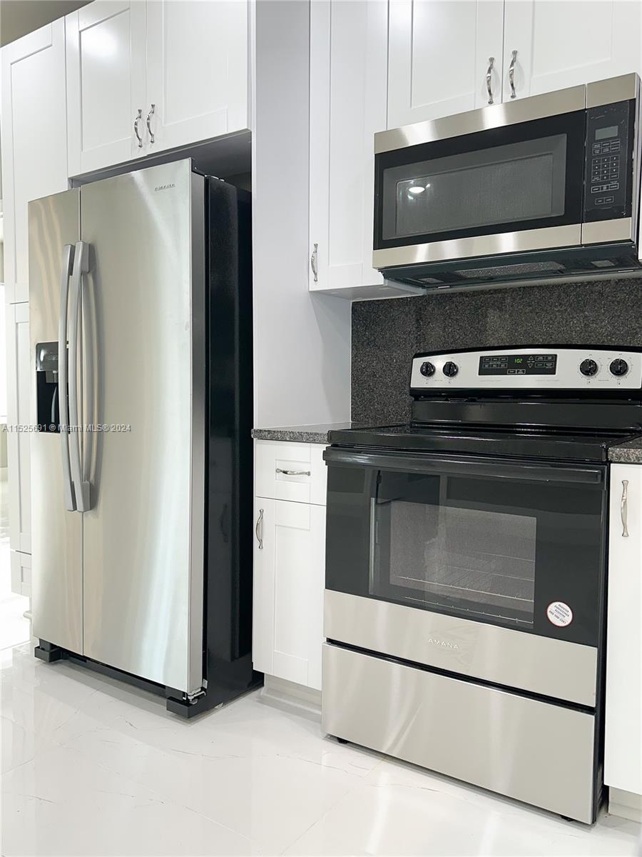 828 Homestead Road South Lehigh Acres, FL 33974 - Photo 11 of 48 a kitchen with appliances and cabinets
