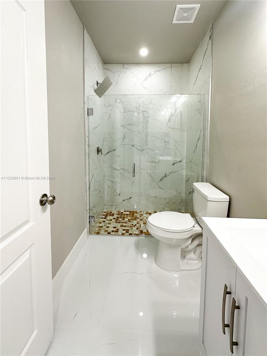 828 Homestead Road South Lehigh Acres, FL 33974 - Photo 15 of 48 a bathroom with a sink a toilet and shower