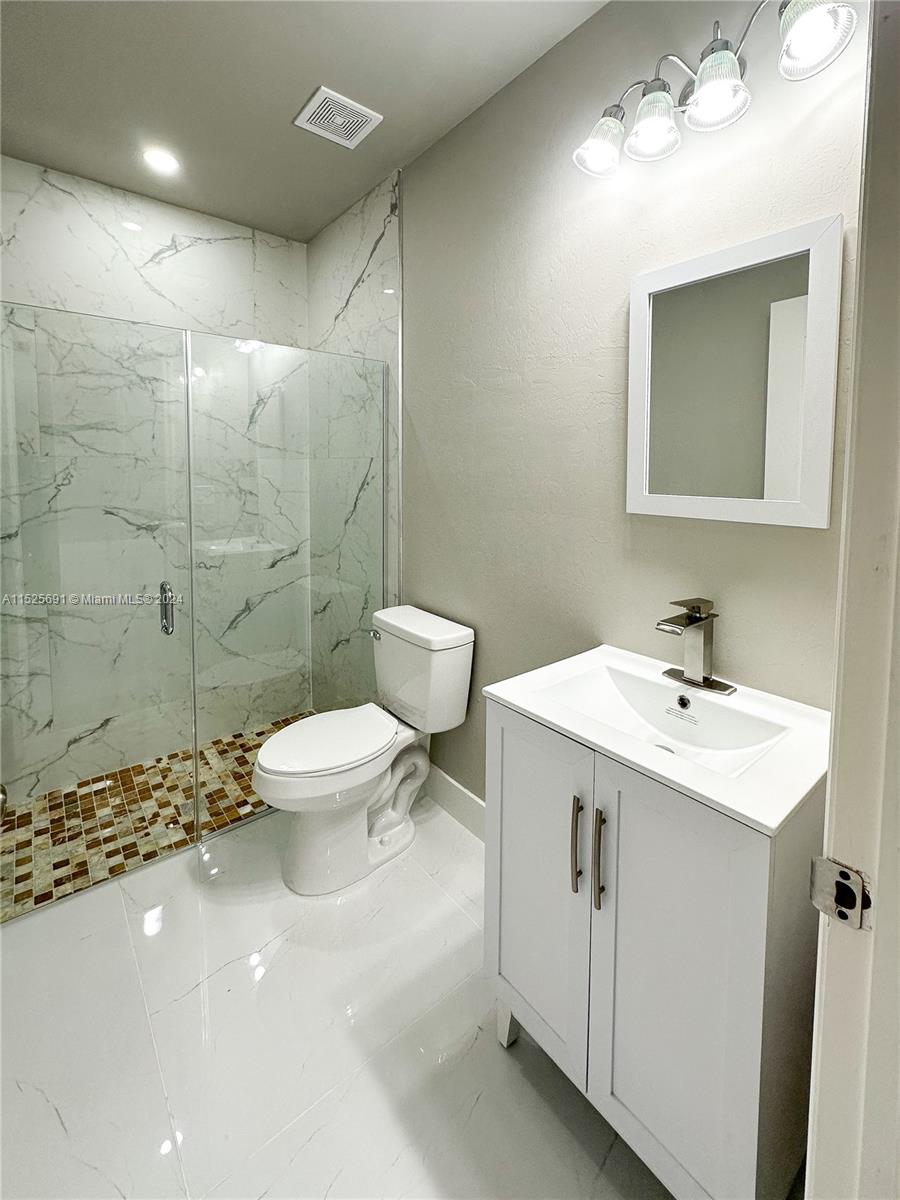 828 Homestead Road South Lehigh Acres, FL 33974 - Photo 16 of 48 a bathroom with a sink toilet and shower