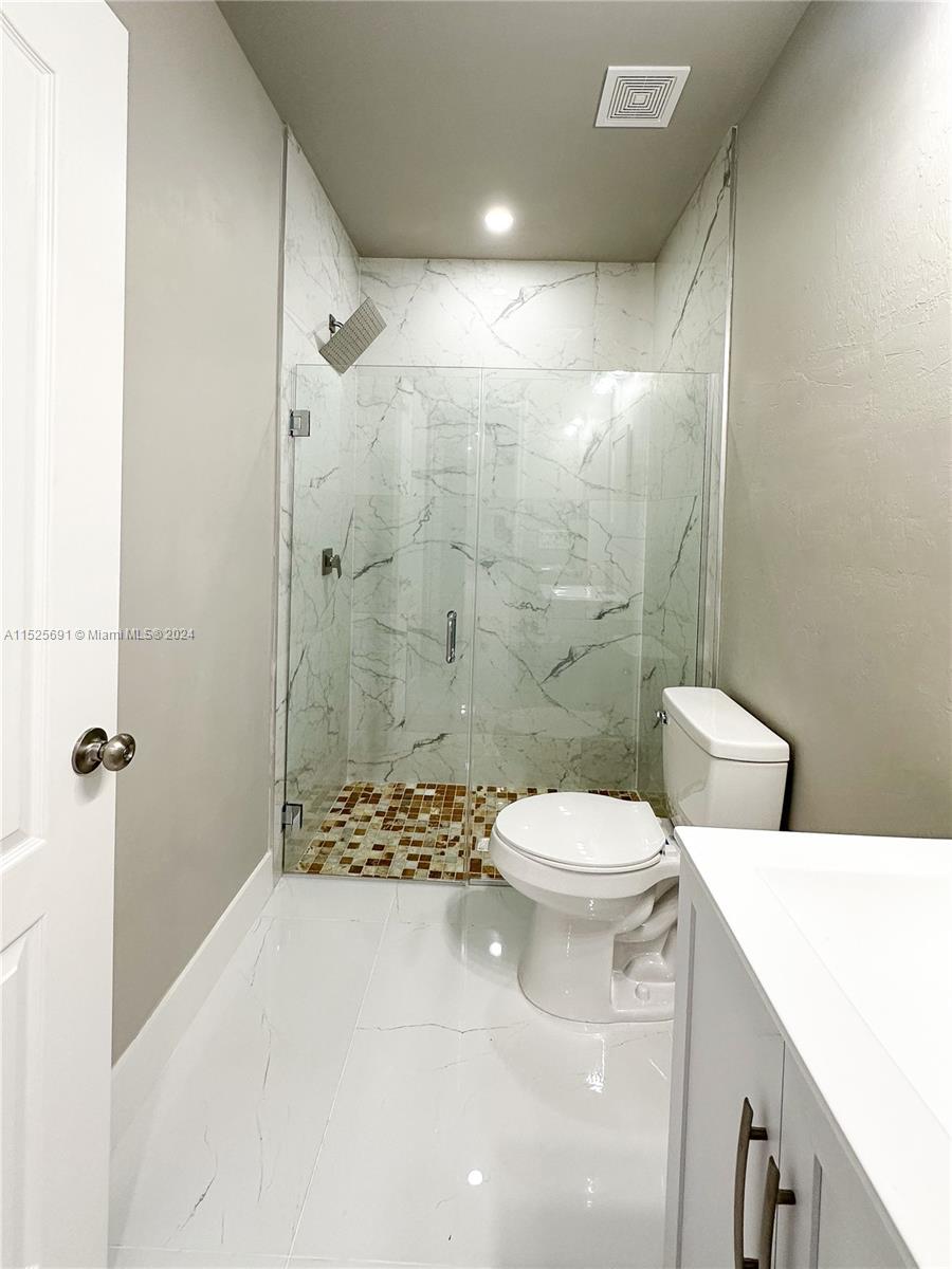 828 Homestead Road South Lehigh Acres, FL 33974 - Photo 18 of 48 a bathroom with a sink a toilet and shower