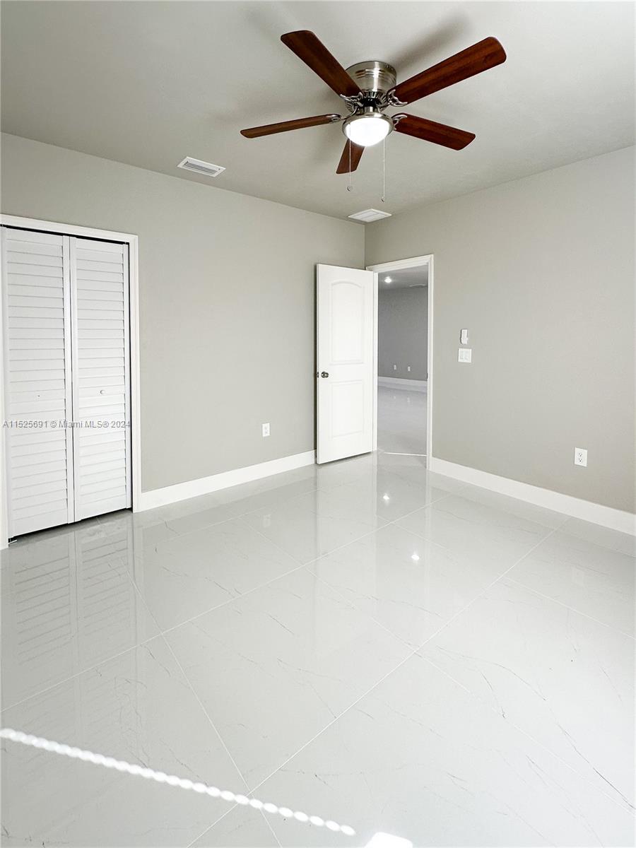 828 Homestead Road South Lehigh Acres, FL 33974 - Photo 24 of 48 wooden floor in an empty room with a window