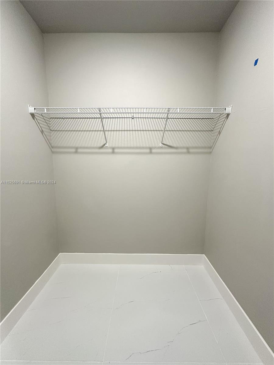 828 Homestead Road South Lehigh Acres, FL 33974 - Photo 28 of 48 a view of a room with racks on the wall