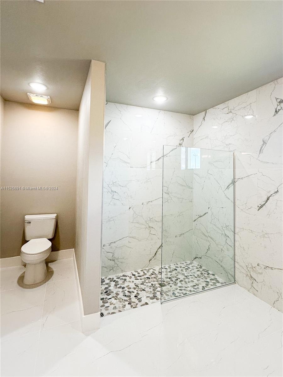 828 Homestead Road South Lehigh Acres, FL 33974 - Photo 30 of 48 a bathroom with a toilet and a shower
