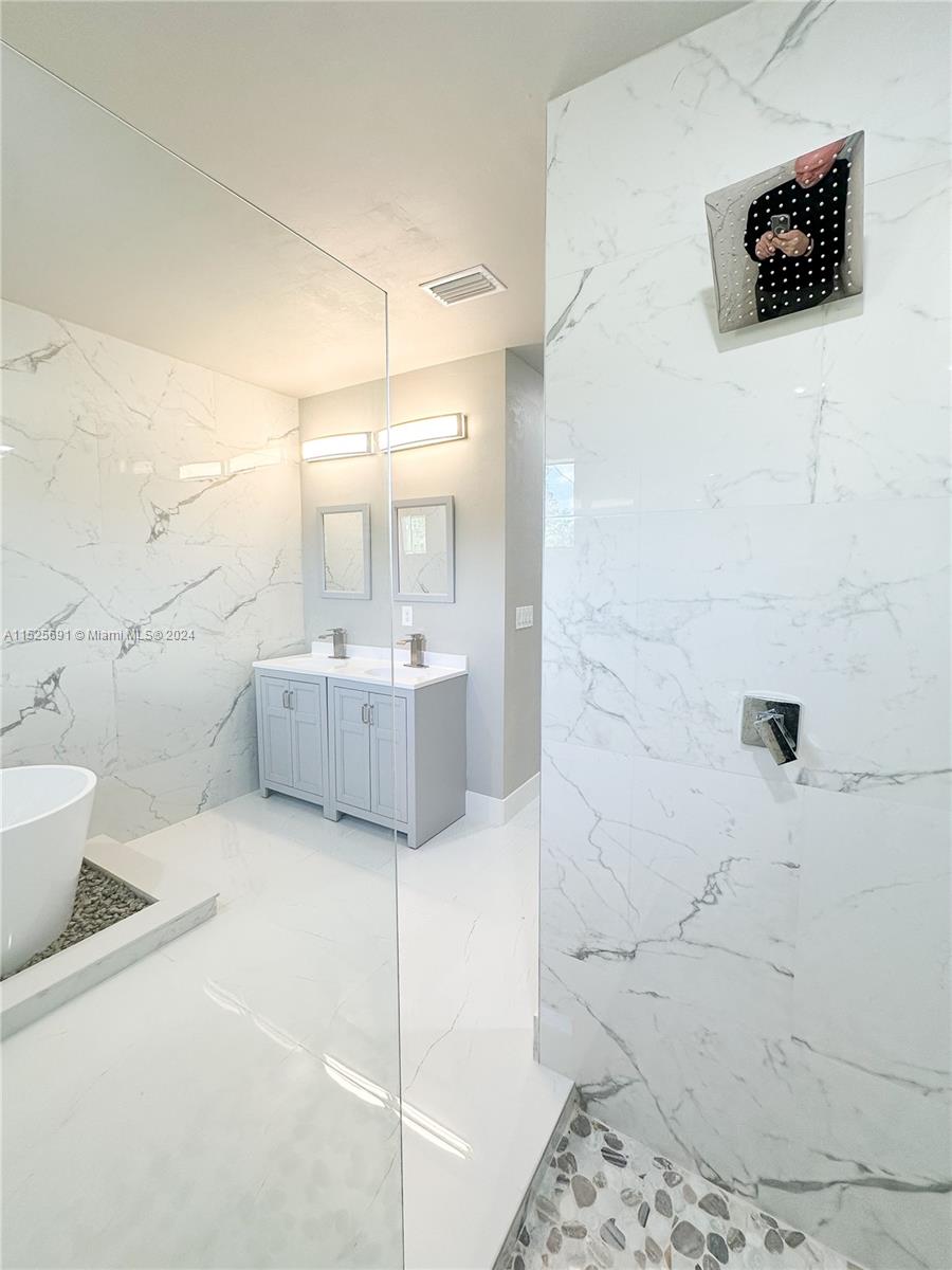 828 Homestead Road South Lehigh Acres, FL 33974 - Photo 32 of 48 a bathroom with a sink a toilet and shower