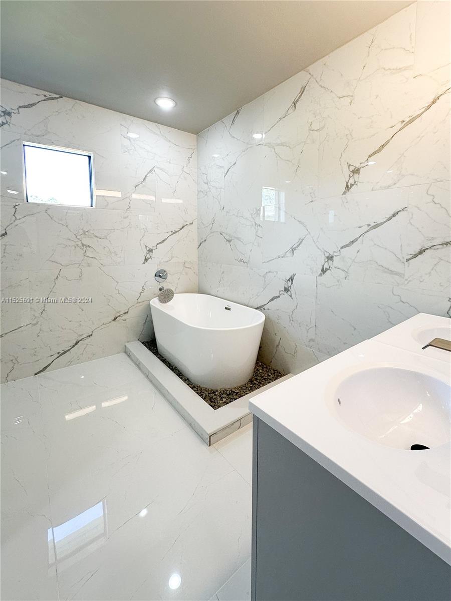 828 Homestead Road South Lehigh Acres, FL 33974 - Photo 35 of 48 a bathroom with a sink and mirror