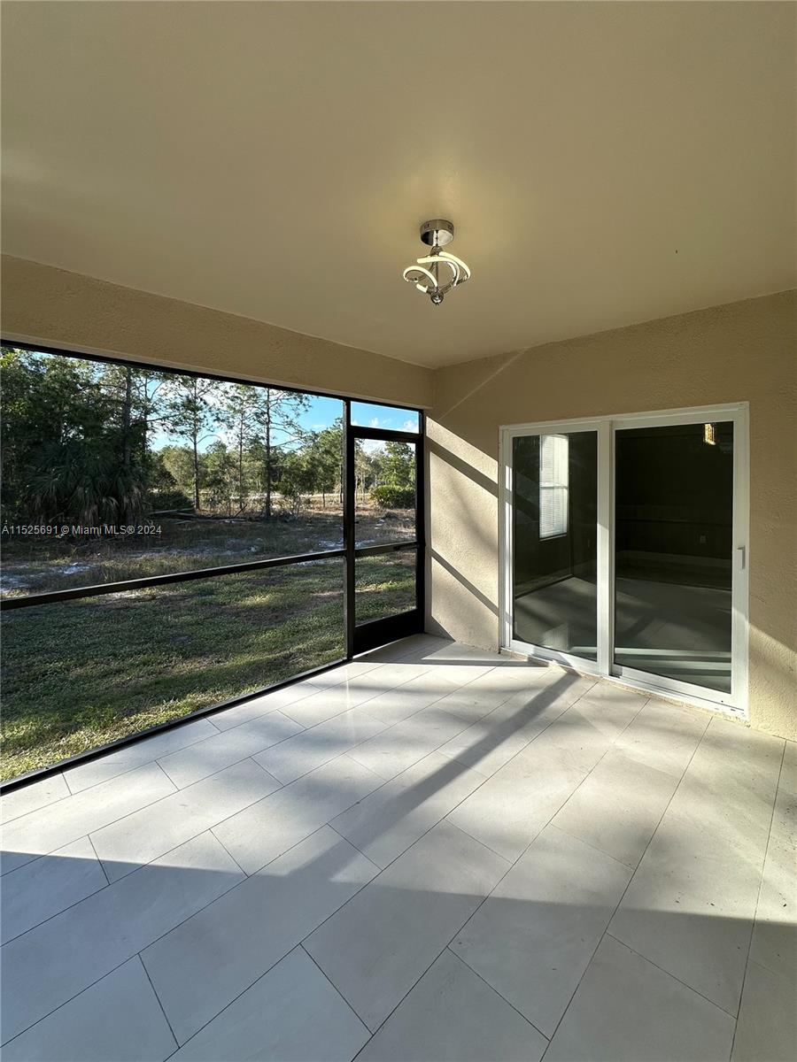 828 Homestead Road South Lehigh Acres, FL 33974 - Photo 41 of 48 a view of an empty room with a fireplace