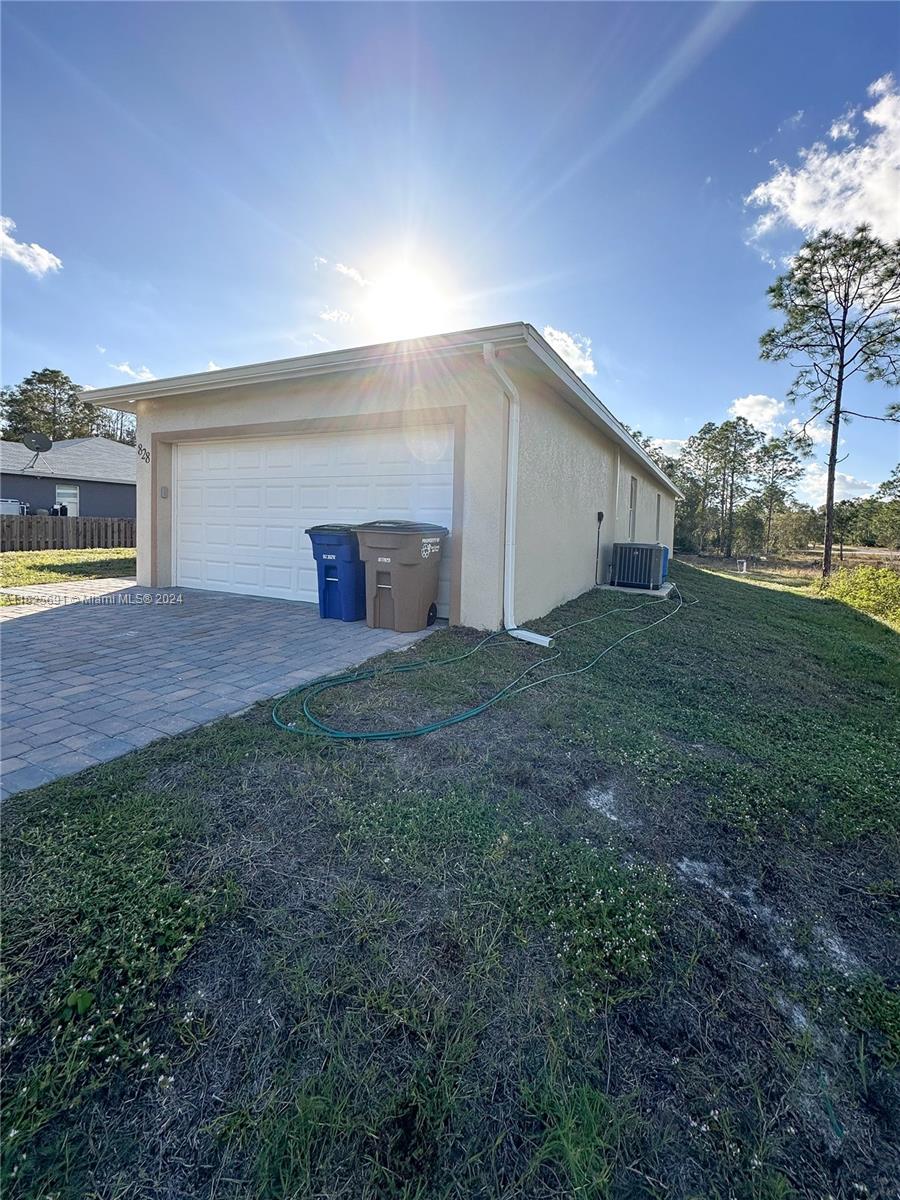 828 Homestead Road South Lehigh Acres, FL 33974 - Photo 46 of 48 a view of an empty room with a garage