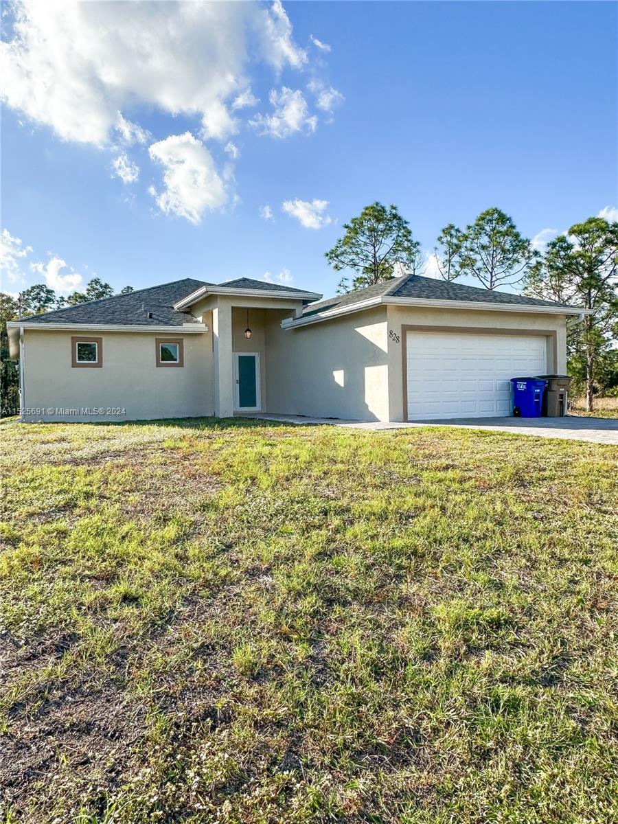 828 Homestead Road South Lehigh Acres, FL 33974 - Photo 48 of 48 a view of a house with a yard