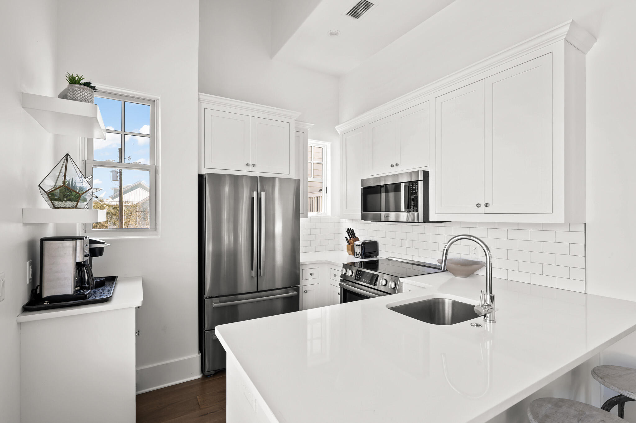 390 Walton Rose Lane Inlet Beach, FL 32461 - Photo 58 of 72 a kitchen with stainless steel appliances a sink a stove and a refrigerator with wooden floor