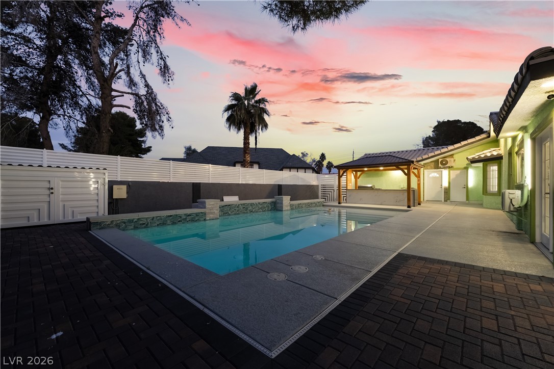 3160 East Viking Road Las Vegas, NV 89121 - Photo 13 of 99 View of swimming pool featuring patio surround, a gazebo, and a fenced backyard
