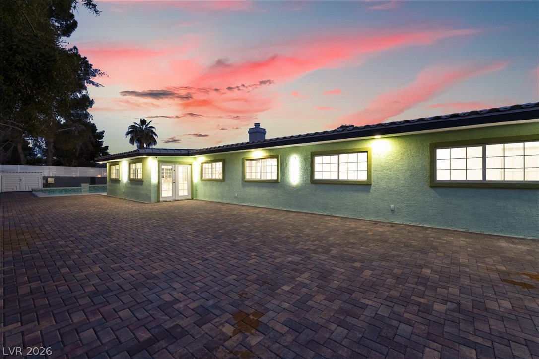 3160 East Viking Road Las Vegas, NV 89121 - Photo 15 of 99 View of front of home featuring stucco siding, french doors, a chimney, and a patio