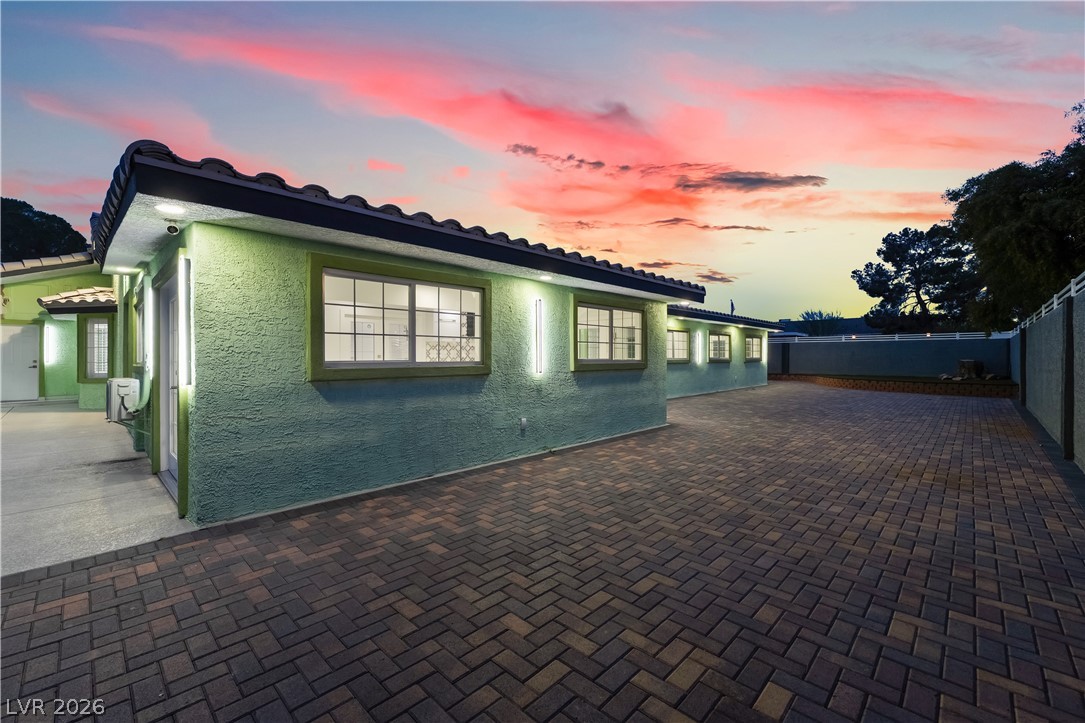 3160 East Viking Road Las Vegas, NV 89121 - Photo 16 of 99 View of side of property with a tiled roof and stucco siding