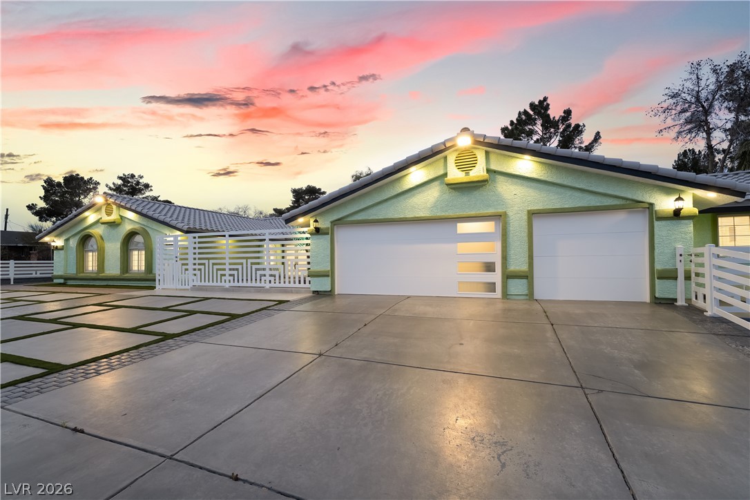 3160 East Viking Road Las Vegas, NV 89121 - Photo 19 of 99 View of front facade with concrete driveway, stucco siding, an attached garage, and a tile roof