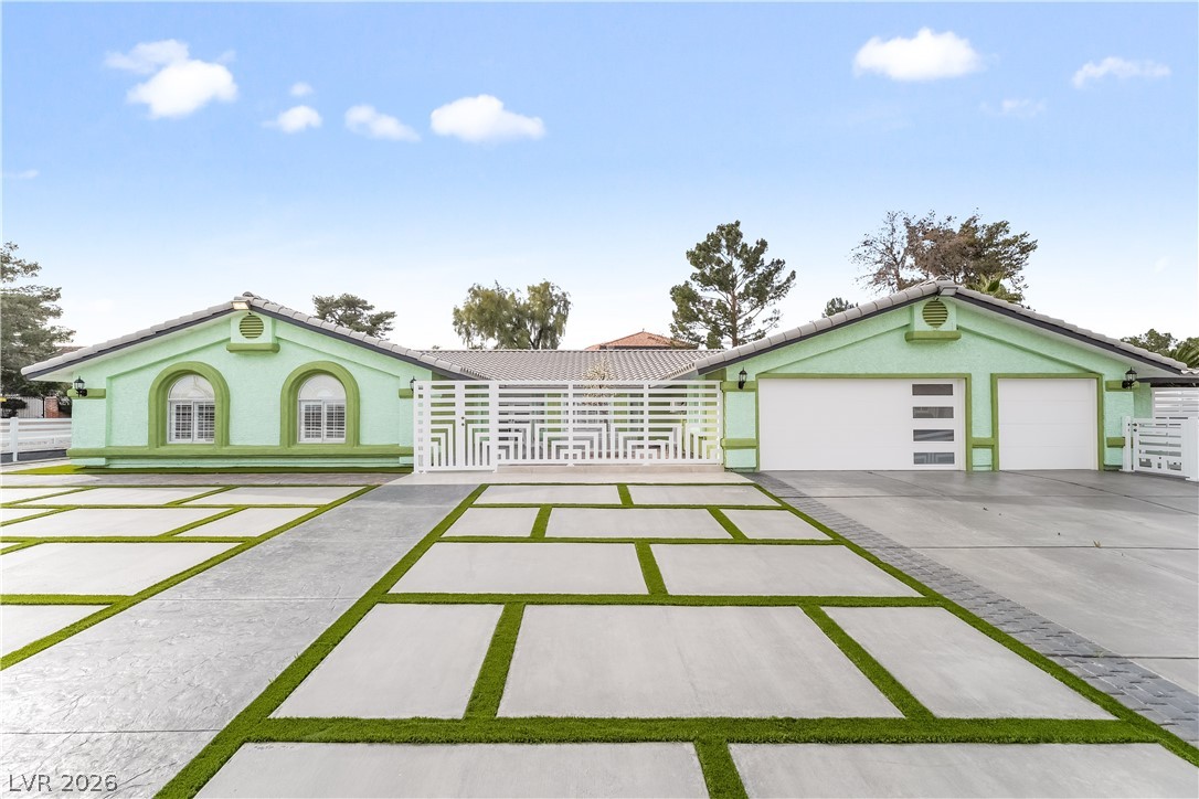 3160 East Viking Road Las Vegas, NV 89121 - Photo 24 of 99 View of front of property featuring stucco siding, a garage, driveway, and a metal roof