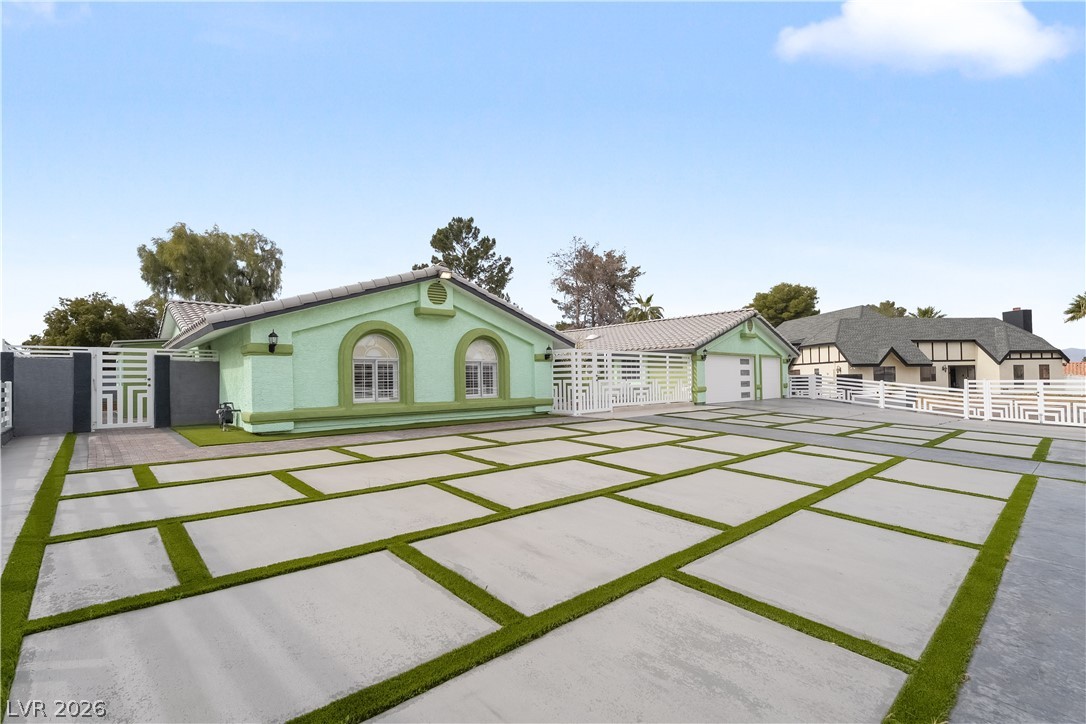 3160 East Viking Road Las Vegas, NV 89121 - Photo 25 of 99 View of front facade with a gate, stucco siding, and a tile roof