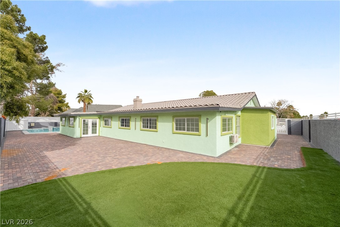 3160 East Viking Road Las Vegas, NV 89121 - Photo 28 of 99 Rear view of property featuring a fenced backyard, french doors, stucco siding, and a patio