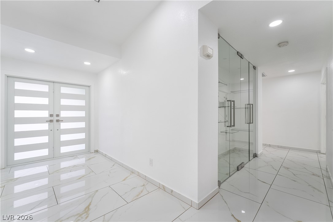 3160 East Viking Road Las Vegas, NV 89121 - Photo 33 of 99 Hall with light marble finish flooring, recessed lighting, and french doors