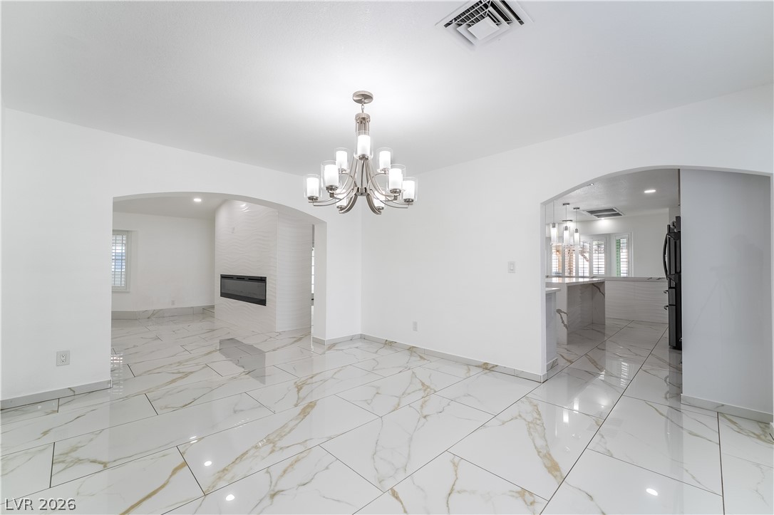 3160 East Viking Road Las Vegas, NV 89121 - Photo 35 of 99 Unfurnished dining area with arched walkways and hanging lights
