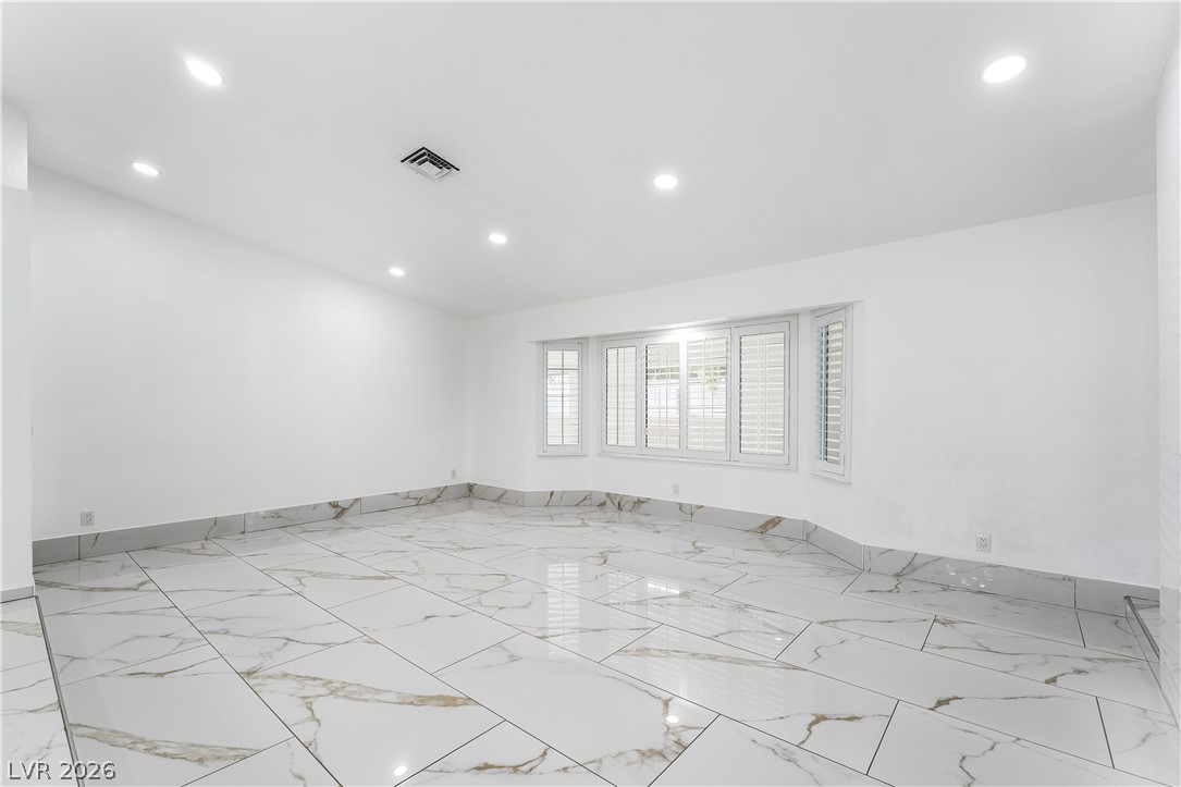 3160 East Viking Road Las Vegas, NV 89121 - Photo 37 of 99 Spare room with recessed lighting and light marble finish floors