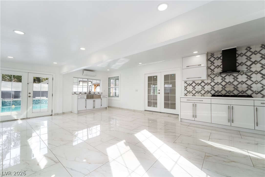 3160 East Viking Road Las Vegas, NV 89121 - Photo 43 of 99 Unfurnished living room featuring french doors and recessed lighting