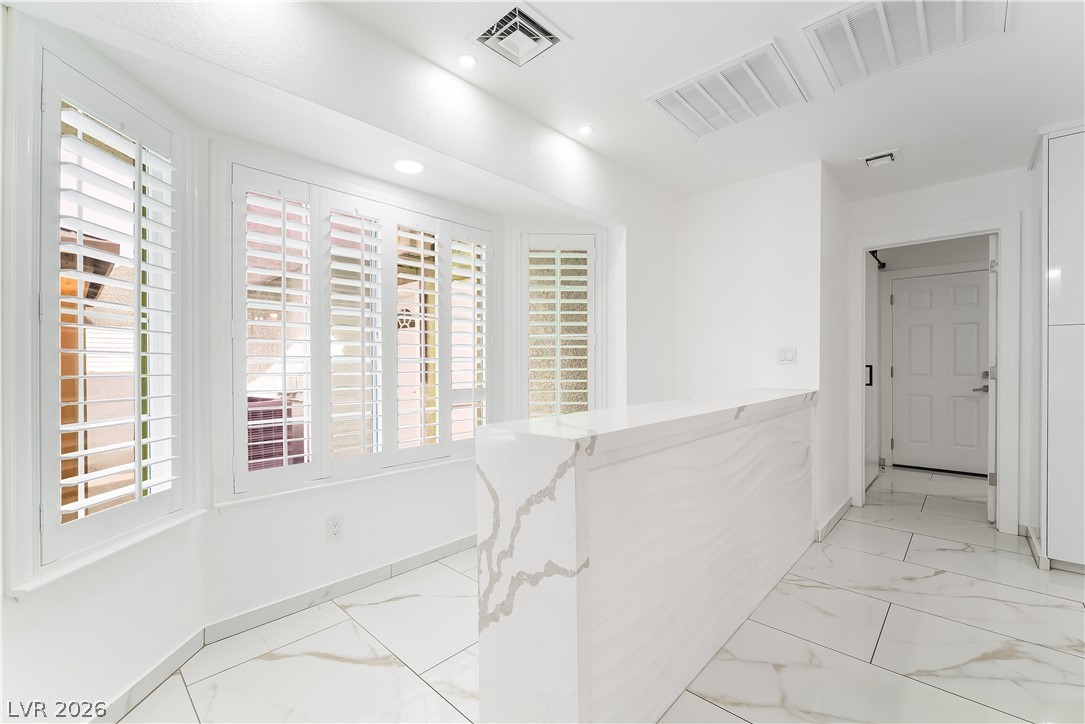 3160 East Viking Road Las Vegas, NV 89121 - Photo 47 of 99 Corridor with light marble finish floors, healthy amount of natural light, and recessed lighting