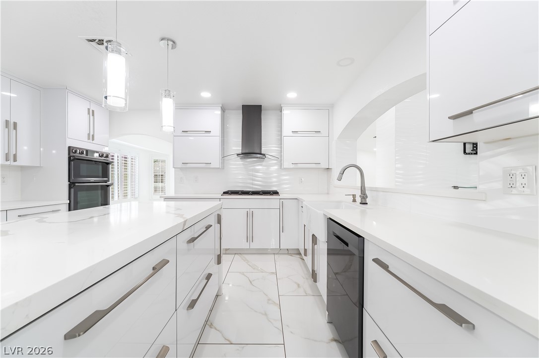 3160 East Viking Road Las Vegas, NV 89121 - Photo 49 of 99 Kitchen with decorative light fixtures, white cabinetry, and modern cabinets