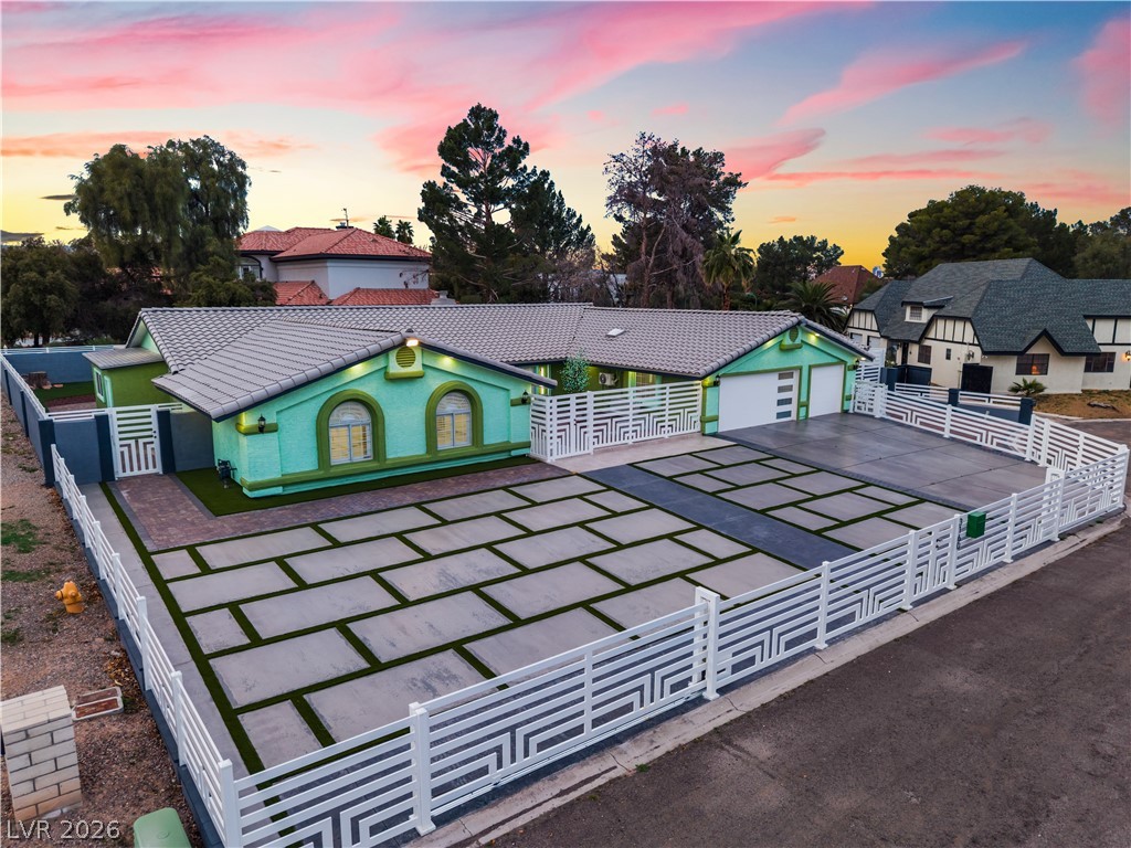 3160 East Viking Road Las Vegas, NV 89121 - Photo 5 of 99 View of front facade featuring a fenced front yard, a tiled roof, asphalt driveway, and a garage