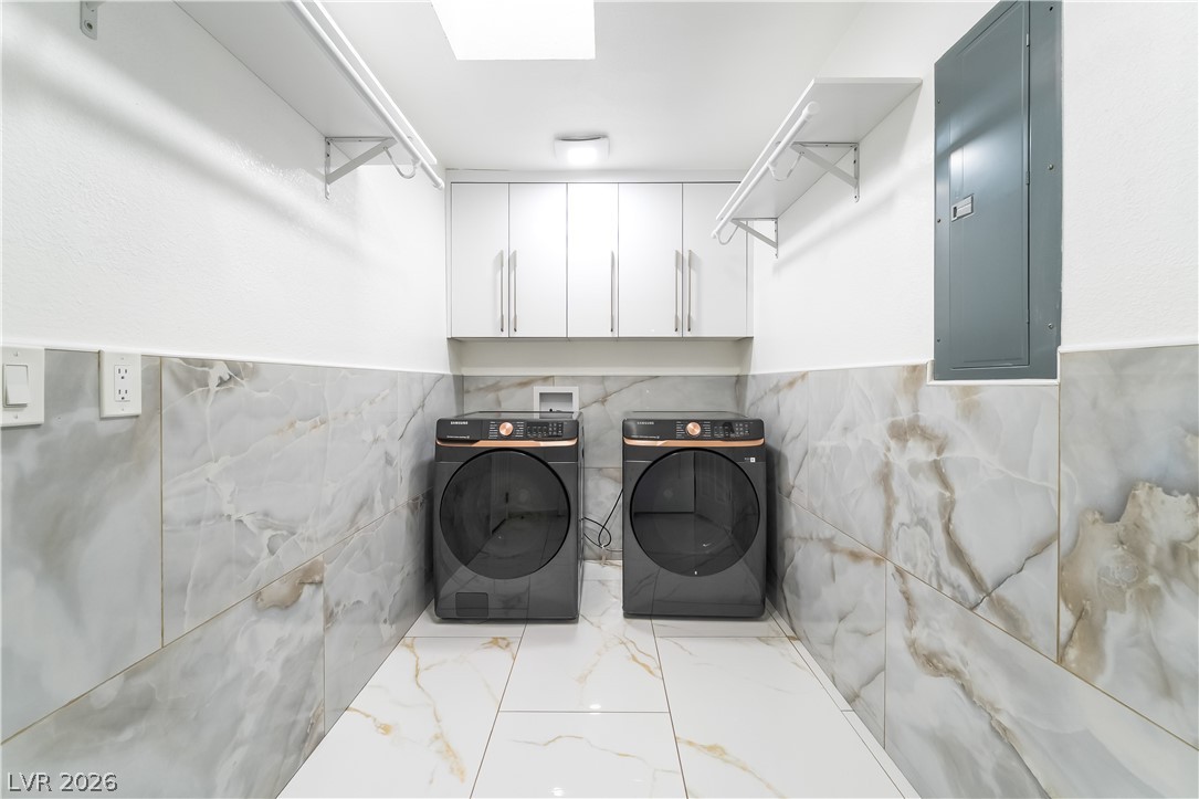 3160 East Viking Road Las Vegas, NV 89121 - Photo 57 of 99 Laundry area featuring electric panel, separate washer and dryer, cabinet space, and marble finish flooring