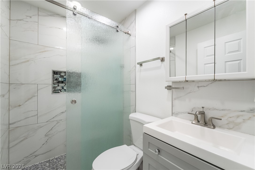 3160 East Viking Road Las Vegas, NV 89121 - Photo 62 of 99 Full bath with a marble finish shower and vanity