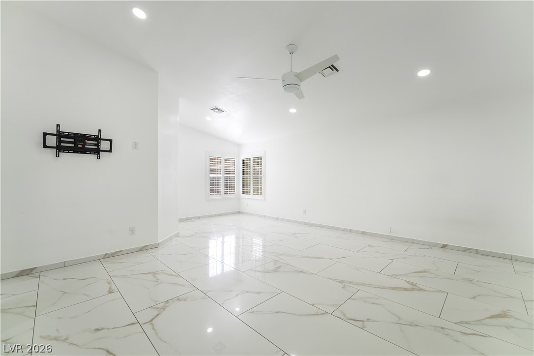 3160 East Viking Road Las Vegas, NV 89121 - Photo 68 of 99 Spare room featuring a ceiling fan, recessed lighting, and vaulted ceiling