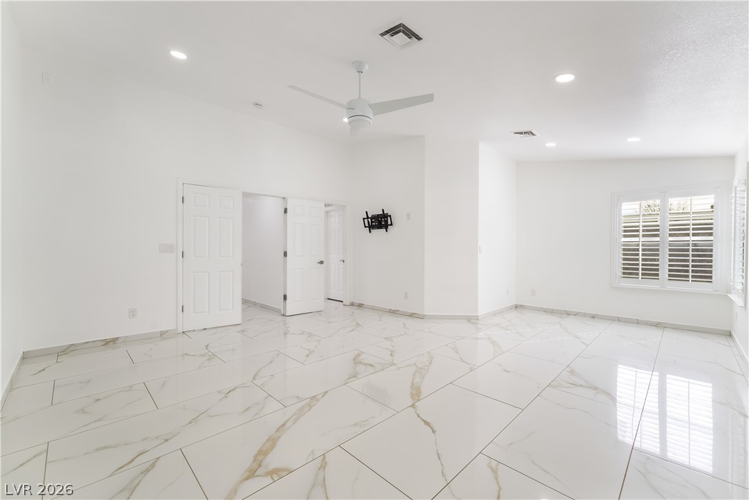 3160 East Viking Road Las Vegas, NV 89121 - Photo 69 of 99 Empty room with recessed lighting, a ceiling fan, and light marble finish floors