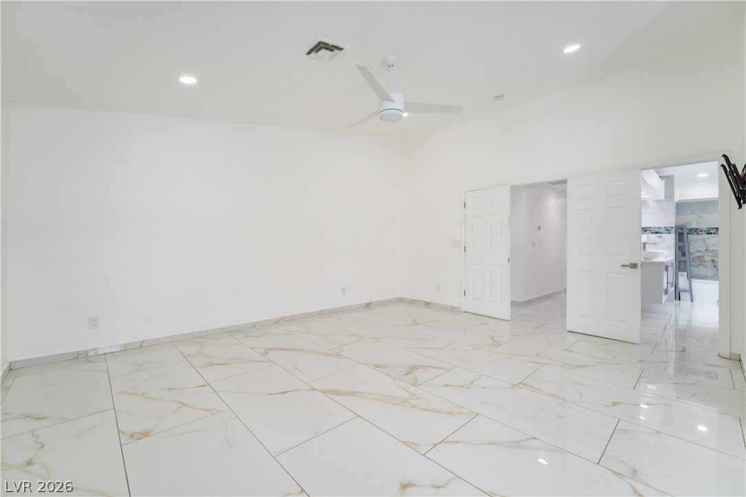 3160 East Viking Road Las Vegas, NV 89121 - Photo 70 of 99 Empty room with ceiling fan, recessed lighting, and light marble finish flooring