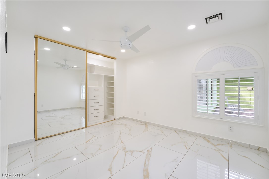 3160 East Viking Road Las Vegas, NV 89121 - Photo 72 of 99 Unfurnished bedroom with ceiling fan, light marble finish floors, recessed lighting, and a closet