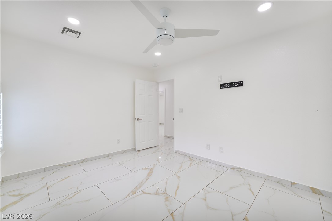 3160 East Viking Road Las Vegas, NV 89121 - Photo 73 of 99 Spare room featuring light marble finish floors, recessed lighting, and a ceiling fan