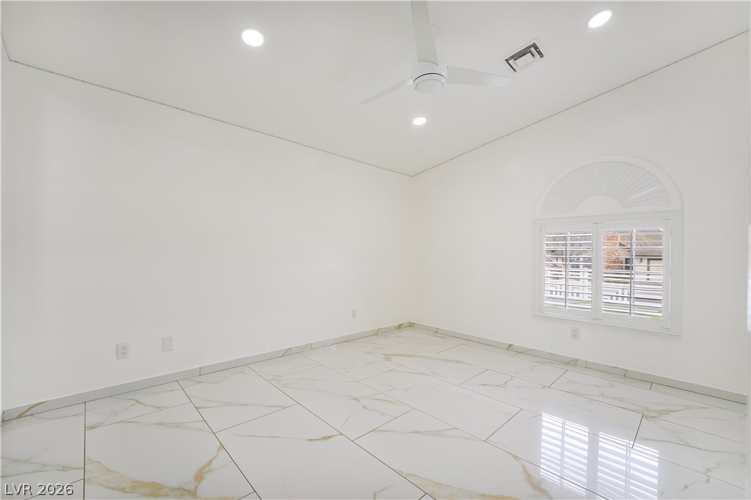 3160 East Viking Road Las Vegas, NV 89121 - Photo 76 of 99 Unfurnished room featuring vaulted ceiling, light marble finish flooring, ceiling fan, and recessed lighting