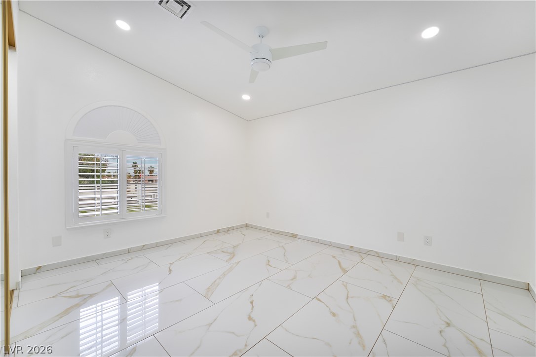 3160 East Viking Road Las Vegas, NV 89121 - Photo 78 of 99 Spare room featuring light marble finish flooring, ceiling fan, recessed lighting, and lofted ceiling