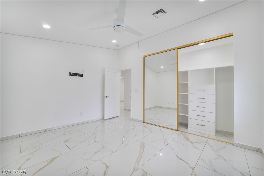 3160 East Viking Road Las Vegas, NV 89121 - Photo 79 of 99 Unfurnished bedroom featuring recessed lighting, a ceiling fan, a closet, and light marble finish flooring