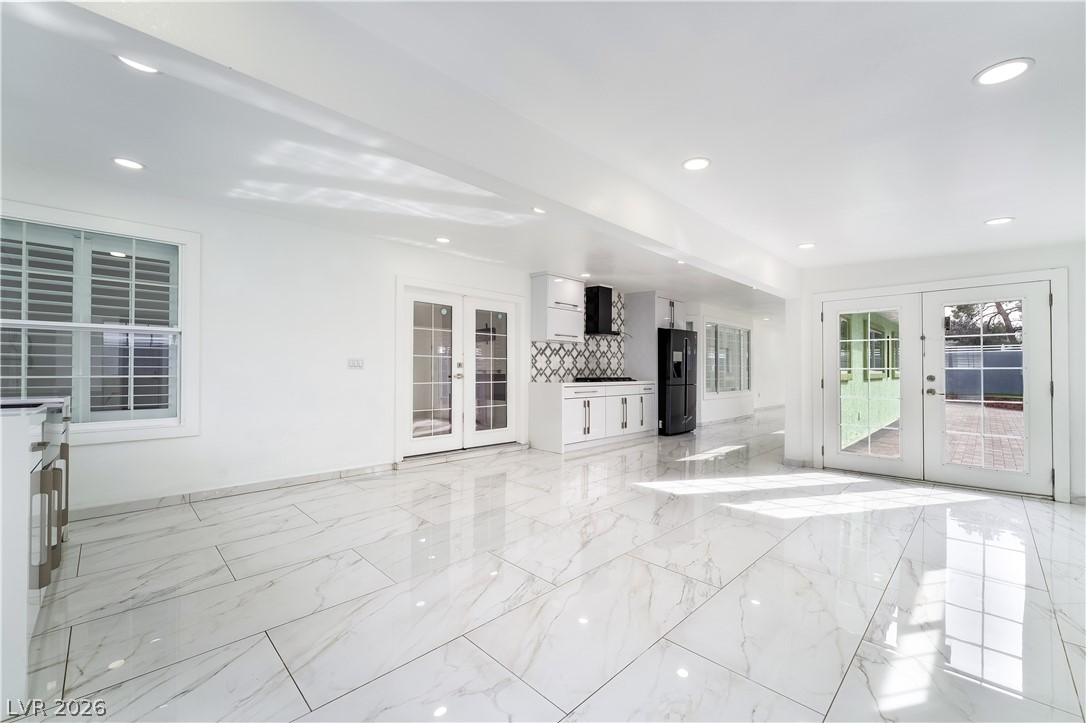 3160 East Viking Road Las Vegas, NV 89121 - Photo 80 of 99 Unfurnished living room featuring french doors and recessed lighting