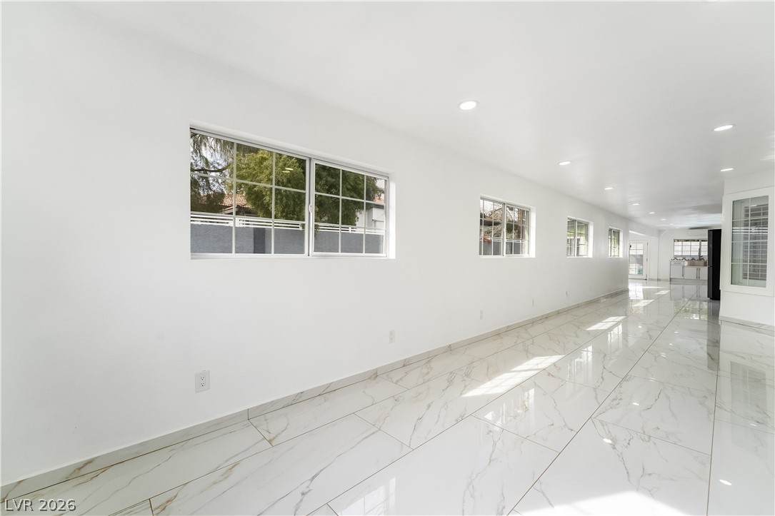3160 East Viking Road Las Vegas, NV 89121 - Photo 81 of 99 Empty room featuring plenty of natural light, recessed lighting, and light marble finish floors