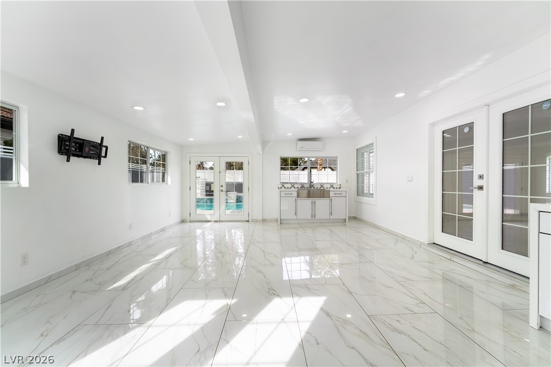 3160 East Viking Road Las Vegas, NV 89121 - Photo 82 of 99 Empty room featuring french doors, recessed lighting, and light marble finish floors