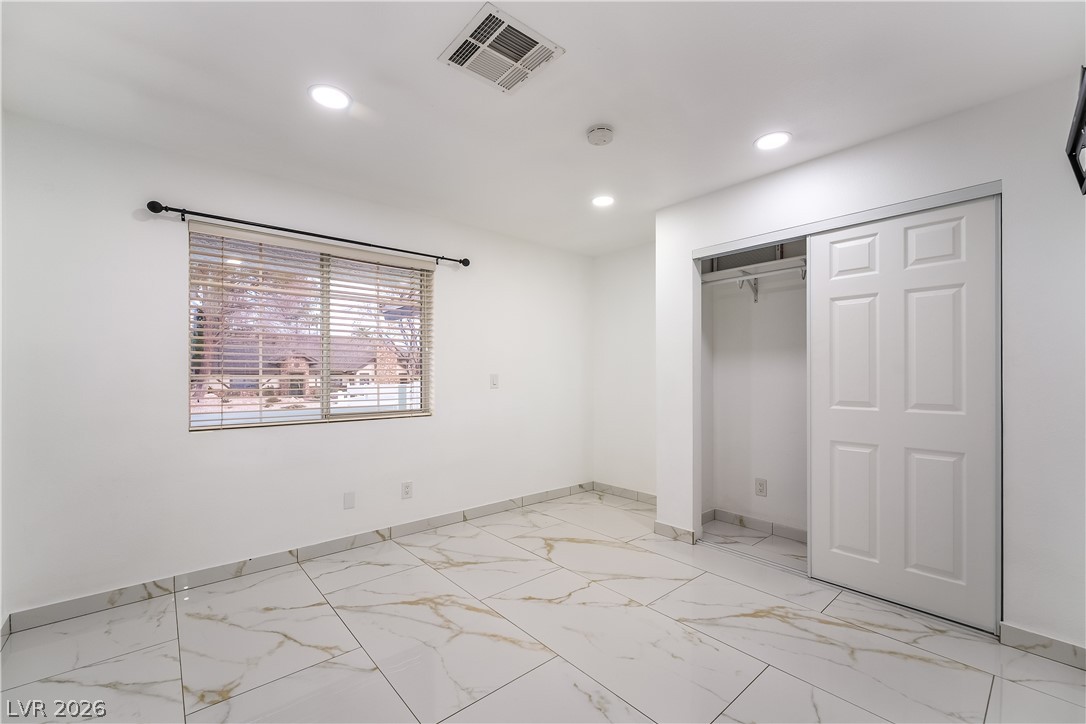 3160 East Viking Road Las Vegas, NV 89121 - Photo 83 of 99 Unfurnished bedroom with light marble finish floors, a closet, and recessed lighting