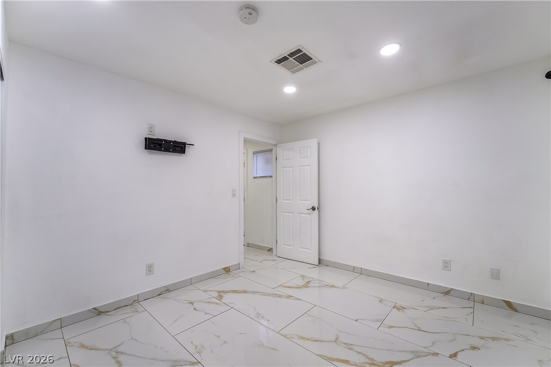 3160 East Viking Road Las Vegas, NV 89121 - Photo 86 of 99 Spare room featuring light marble finish flooring and recessed lighting