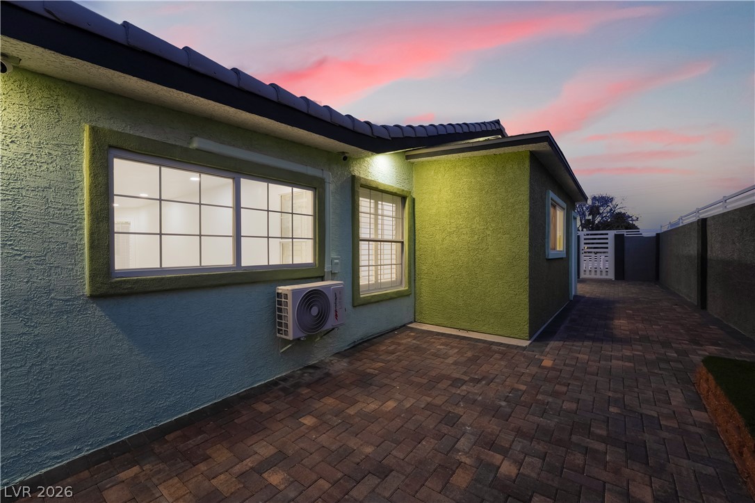 3160 East Viking Road Las Vegas, NV 89121 - Photo 89 of 99 View of property exterior featuring stucco siding, a patio, and a tiled roof