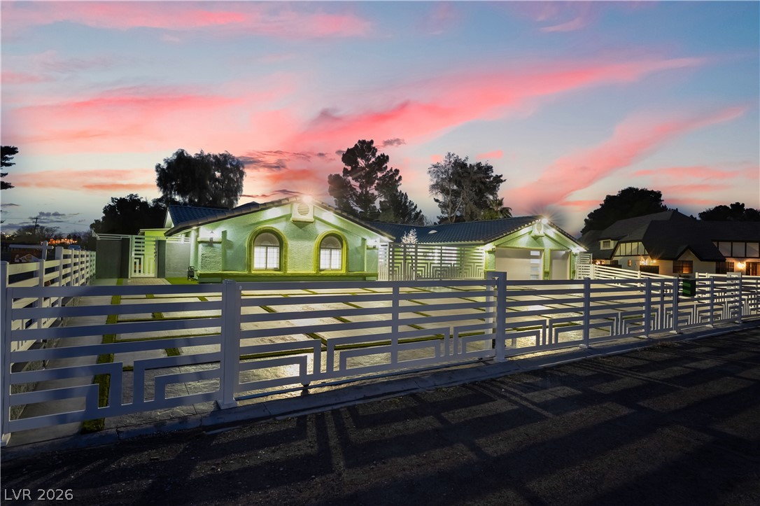 3160 East Viking Road Las Vegas, NV 89121 - Photo 9 of 99 View of front of house featuring a metal roof, a fenced front yard, and a gate